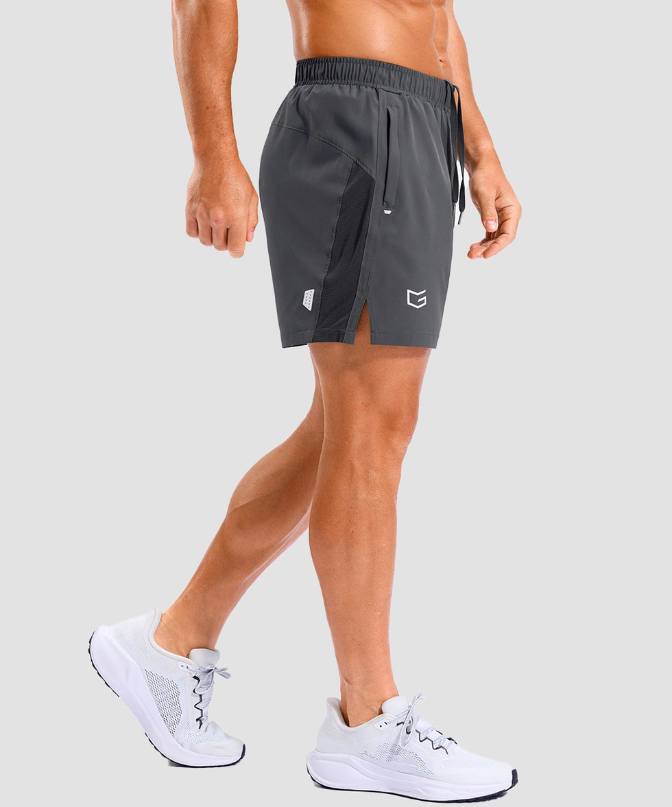 lightweight 5" pocketed athletic shorts in dark gray - on model side view