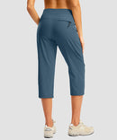 women's 3 zipper pockets hiking capri pants in indigo blue - back view