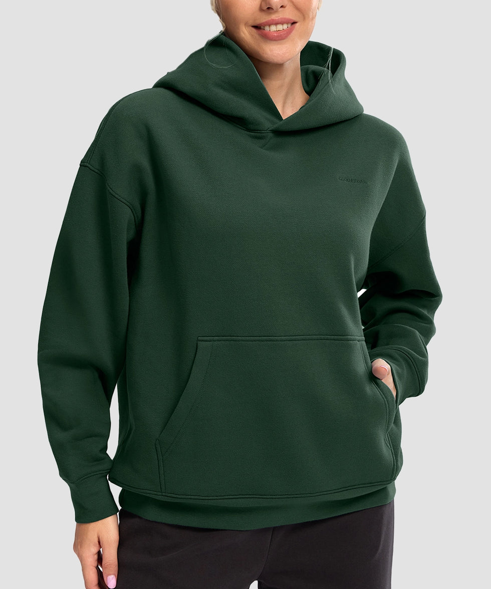 women's solid color oversized fleece hoodie in dark green - front view
