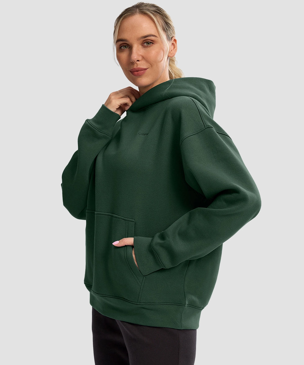 women's solid color oversized fleece hoodie in dark green - side view