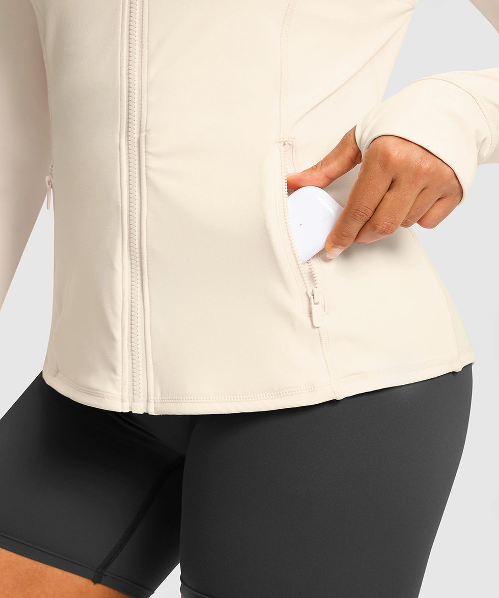 women's zip-up slim fit hip length jacket in beige - zipper pocket detail view