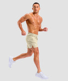 lightweight 5" pocketed athletic shorts in light khaki - on model side view