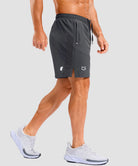 lightweight 7" pocketed athletic shorts in dark gray - on model side view