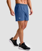 mid rise elastic waist slit short 5" in dusty blue - on model side view