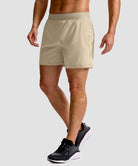 mid rise elastic waist slit short 5" in light khaki - on model side view