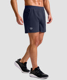 mid rise elastic waist slit short 5" in navy - on model side view