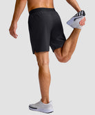 mid rise elastic waist slit short 7" in black - on model back view