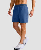 mid rise elastic waist slit short 7" in dusty blue - on model side view