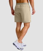 mid rise elastic waist slit short 7" in light khaki - on model back view