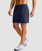 mid rise elastic waist slit short 7" in navy - on model side view