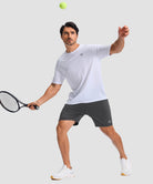 moisture wicking athletic sweat shorts in heather gray - on model play tennis view