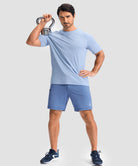 moisture wicking athletic sweat shorts in heather haze blue - on model kettlebell workout view