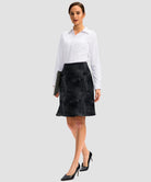ruffle modest golf skort in black tie-dye - front view