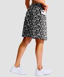 women's 4 pockets knee length golf skort in black flower - back view