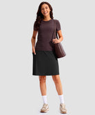 women's 4 pockets knee length golf skort in black - front view