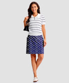 women's 4 pockets knee length golf skort in navy circle - front view
