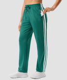 women's contrast stripe zip pockets track pants 30''/32'' in forest green - pocket detail