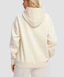 women's solid color oversized fleece hoodie in beige - back view