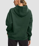 women's solid color oversized fleece hoodie in dark green - back view