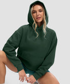 women's solid color oversized fleece hoodie in dark green - collar detail view
