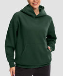 women's solid color oversized fleece hoodie in dark green - front view