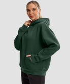 women's solid color oversized fleece hoodie in dark green - side view