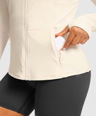 women's zip-up slim fit hip length jacket in beige - zipper pocket detail view